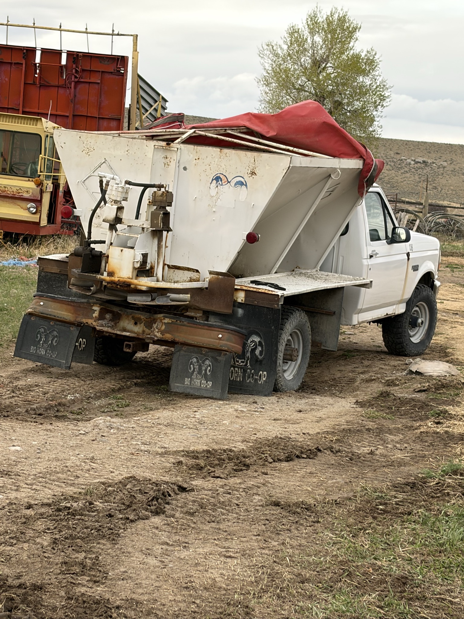 White farm truck fitted with soil amendment spreading equipment
