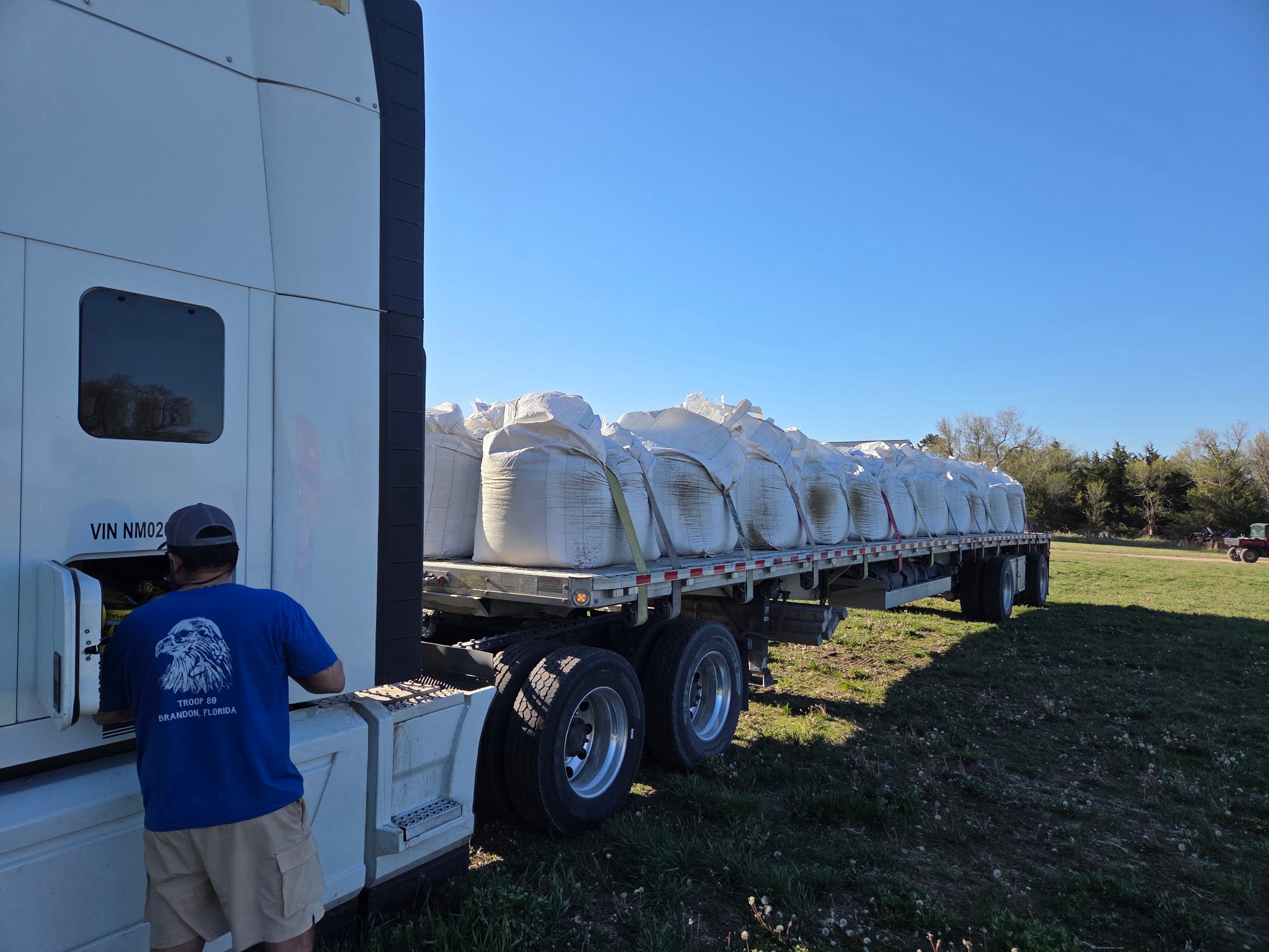 Truckload of white super sacks loaded on a flatbed trailer